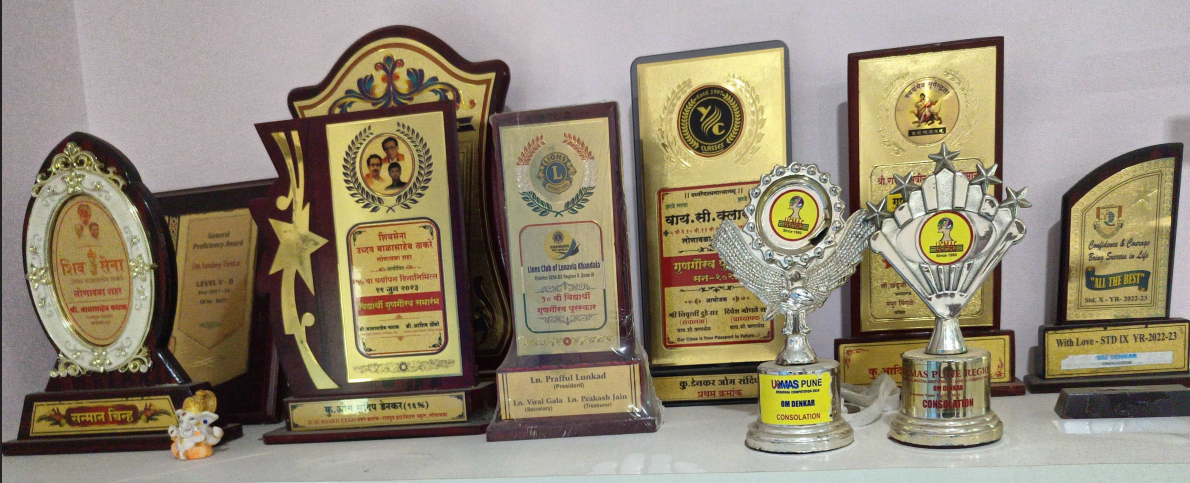 Trophy shelf spanning 2014–2023 — academic, olympiad, and inter-school awards